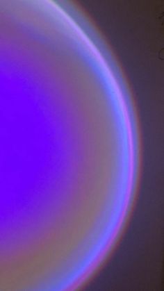 a blue and purple circular object in the dark