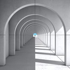 an empty hallway with arches leading into the light