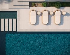 an aerial view of a swimming pool with concrete pillars