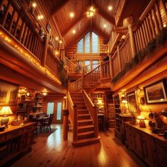 the inside of a log cabin with stairs leading up to two levels and lights on