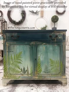 an old dresser painted green with fern leaves on it and the words, image of hand painted piece graciously provided by turquoise for virtual display of id transfer