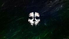 a dark green background with a white skull on it's face in the center