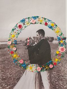 a man and woman are standing in front of a circular frame with flowers on it