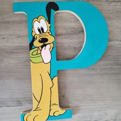 the letter p is painted like a cartoon dog with a bowl of food in its mouth