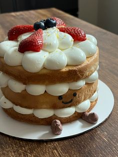 a cake with strawberries and whipped cream on top