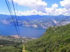 a view from the top of a cable car looking down on a lake and mountains