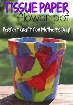 a colorful flower pot sitting on top of a wooden table with text overlay that reads tissue paper flower pot perfect craft for mother's day