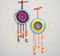 two colorful wind chimes hanging on a wall