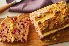 a loaf of bread sitting on top of a wooden cutting board next to a knife