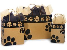 three brown paper bags with black and white paw prints