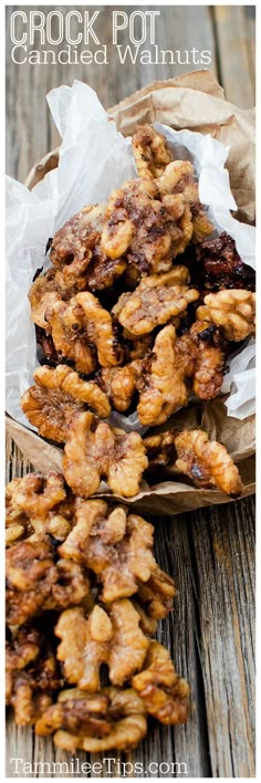 crock pot candied walnuts on a wooden table with text overlay that reads crock pot candied walnuts