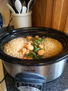 a crock pot filled with rice and vegetables