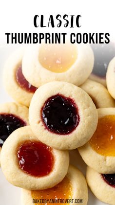 some cookies with jam on them and the words classic thumbprint cookies