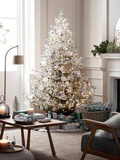 a white christmas tree in a living room