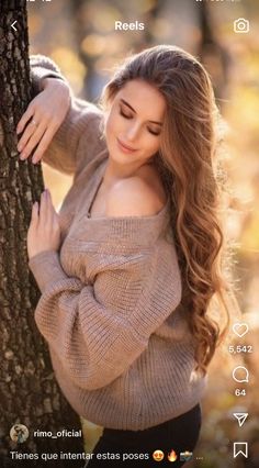 a beautiful young woman leaning against a tree