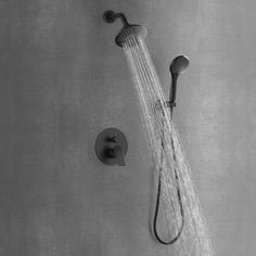 the shower head and handset are shown in black and white, with water flowing from it