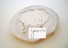 a silver bracelet with the word you're on it and a name tag attached to it