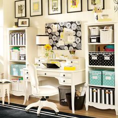 a white desk topped with a laptop computer next to a book shelf filled with books