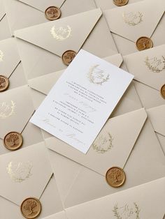 many different types of envelopes with gold foil on them