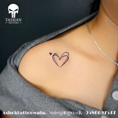 a woman with a heart tattoo on her left shoulder and two hearts in the middle