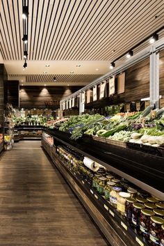 a grocery store filled with lots of fresh produce and vegetables in it's shelves