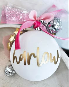 a white ornament with gold lettering on it