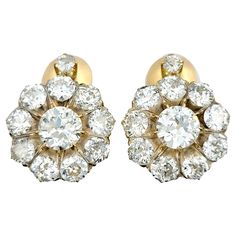 This stunning pair of antique diamond clip-on earrings, set in radiant 14 karat yellow gold, is a classic and elegant choice that exudes timeless beauty. The use of round old European cut diamonds adds a vintage charm to the earrings, and the arrangement of a larger diamond at the center surrounded by slightly smaller diamonds creates a captivating and harmonious design. The warm tones of the yellow gold setting complement the sparkle of the diamonds, enhancing their brilliance. The clip-on styl Earring Box, Gold Clips, Yellow Gold Setting, European Cut Diamonds, Antique Diamond, Diamond Halo, Halo Diamond, Earrings Set, Vintage Charms