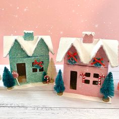 two small houses are decorated with christmas decorations