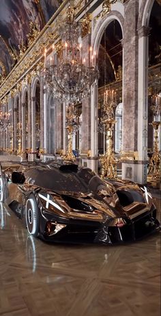 a very fancy looking car parked in a big room with chandeliers on the ceiling