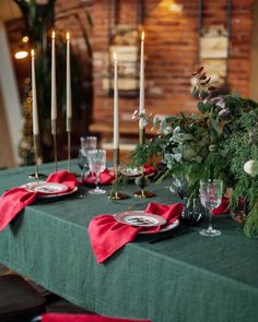 the table is set with candles and place settings