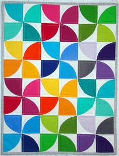 a multicolored quilt with circles on it