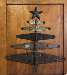 a wooden door with a metal christmas tree on it