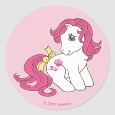 a pink sticker with an image of a pony and a cat on it's back