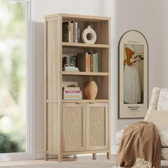 a living room with a book shelf and a bed