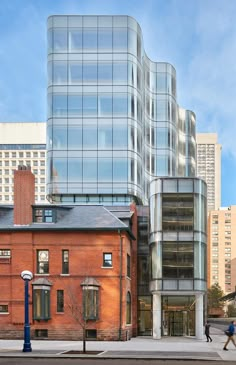 a tall building with many windows next to a street