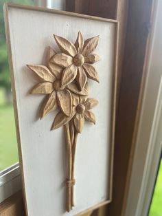 a wooden frame with a flower on it