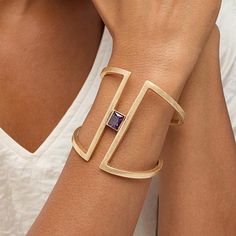 MarlaWynne Minimalist Accent Stone Wide Cuff Bracelet Drab duds who? Not you. Freshen up those old familiar fashions. Accessorize with this modern cuff's bold, yet spacious silhouette featuring a split  design and purple solitaire.       S/M approx. 6-5/8"L      M/L approx. 6-3/4"L     Approx. 2-9/16"W     Worn finish      Tapered back; hinged Modern Cuff Bracelet, Cuff Bracelets Gold, Statement Cuff Bracelet, Wide Cuff Bracelets, Split Design, Gold Bracelet Cuff, Ancient Jewelry, Hinged Bracelet, Wide Cuff