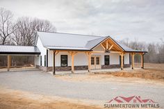 a large white building sitting on top of a dirt field