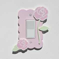 a light switch cover with pink roses on it