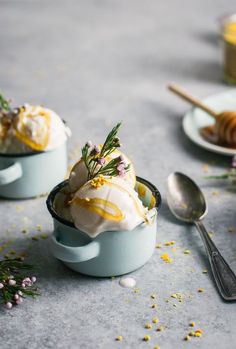 two bowls filled with ice cream next to spoons