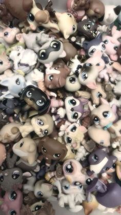 there are many small toy animals together in this pile, all different colors and sizes