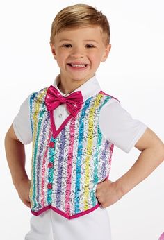 a young boy wearing a colorful vest and bow tie with his hands on his hips