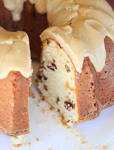 a bundt cake with frosting on a white plate