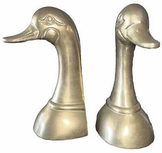 two metal ducks sitting next to each other