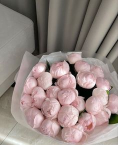 a bouquet of pink flowers sitting on top of a table