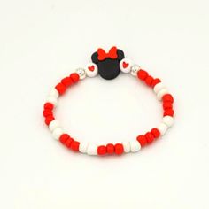 red and white beaded bracelet with mickey mouse head on the front, black heart at the back