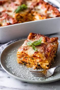 a slice of lasagna on a plate with a fork