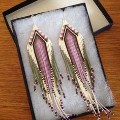 two pairs of beaded earrings in a box