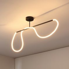 a light that is on the ceiling in a room with white walls and flooring