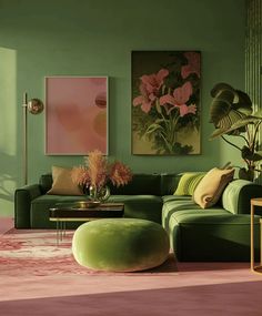 a living room with green couches and pink rugs on the floor in front of paintings